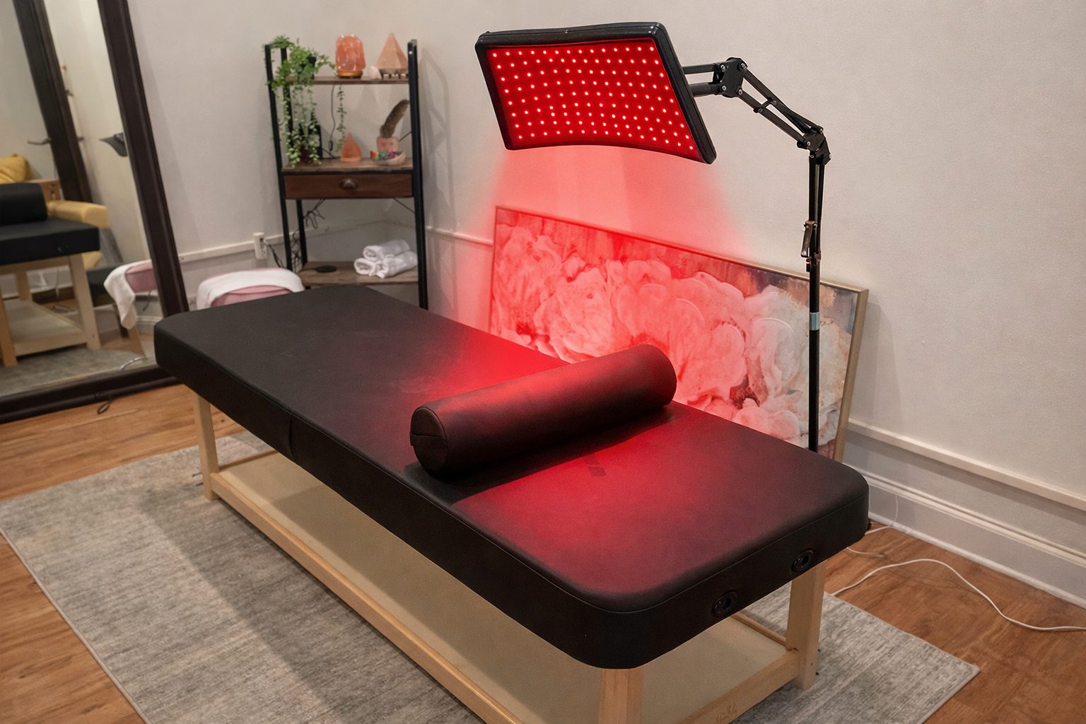 The Spryvitality wellness suite with a massage table under a red light therapy panel